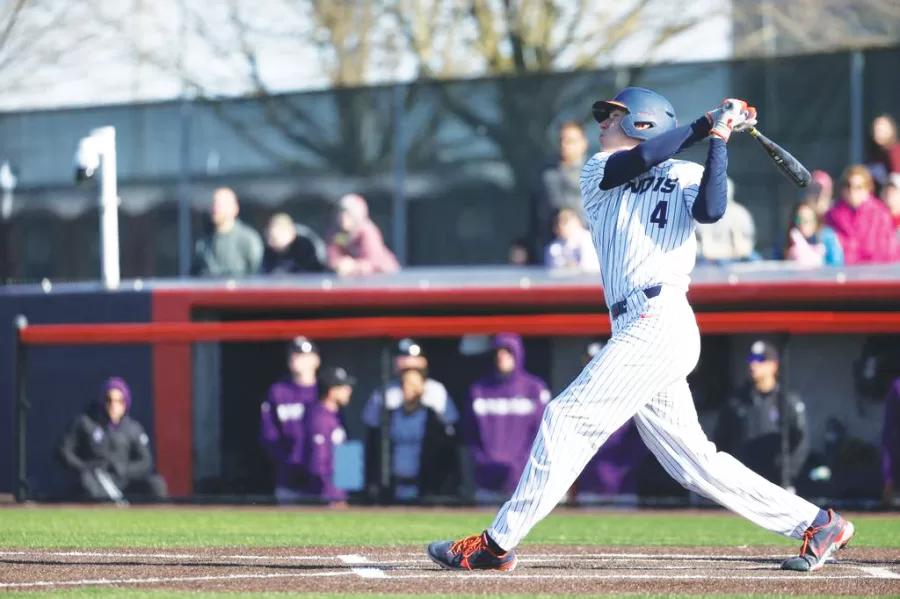 Senior infielder/outfielder Cam McDonald follows through on a swing during a game against Northwestern on April 16, 2022. During last season, McDonald set the record for most consecutive games on base.