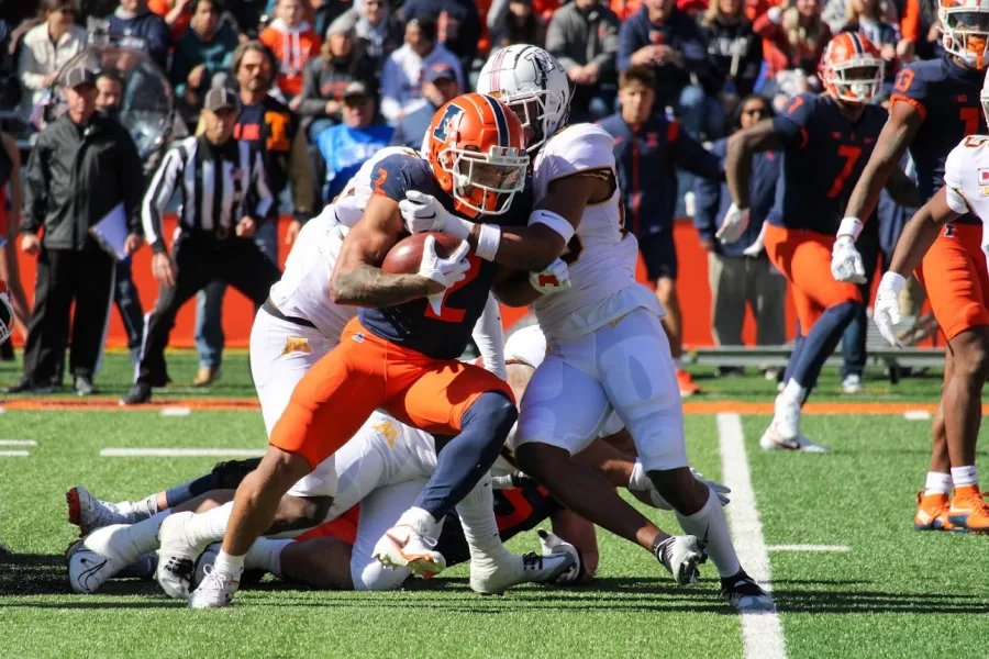 Defensive back Matthew Bailey attempts to get through Minnesota on Oct. 15.
Baileys defense for the Illini this season demonstrates a positive potential future for the team.  
