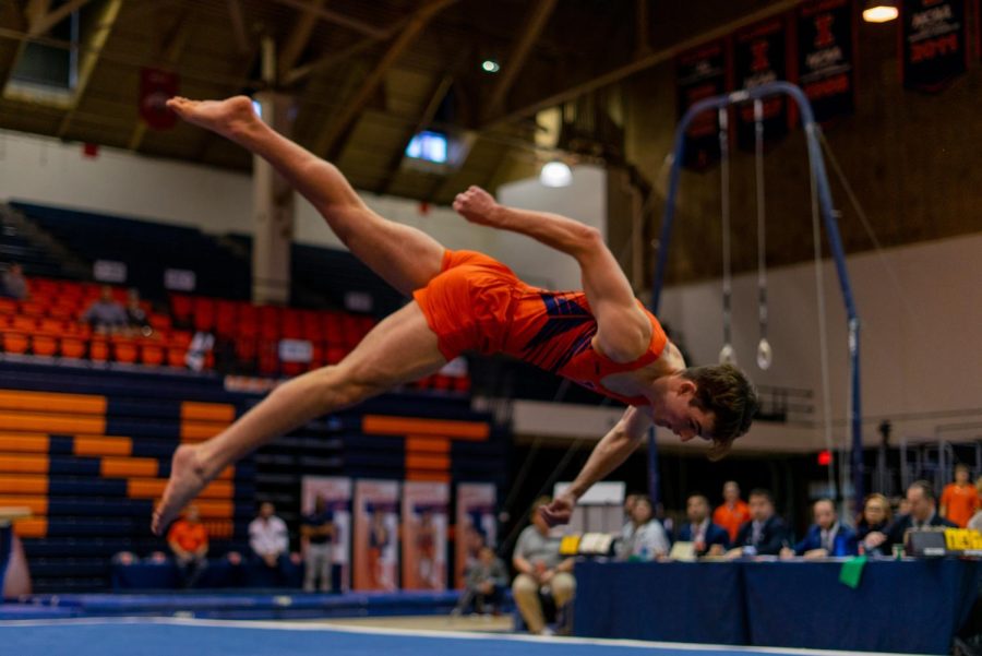 Senior+Connor+McCool+flips+during+his+first-place+floor+routine+on+Feb.+4%2C+scoring+14.400+points.