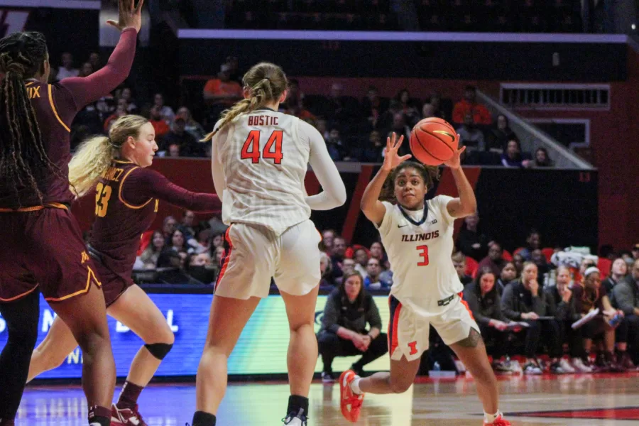 Junior guard Makira Cook passes to junior forward Kendall Bostic against Minnesota on Sunday. On Thursday, Illinois beat Nebraska for the first time in five years, in large part due to a strong performance from Cook, as well as  sophomore guard Adalia McKenzie. The duo combined for a total of 41 points.