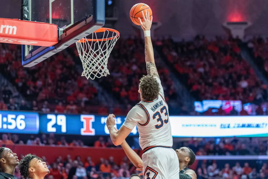 Junior forward Coleman Hawkins jumps for the ball during the game against Rutgers on Saturday. After a staunch turnaround during the second half, Illinois came out ahead, with a final score of 69-60.