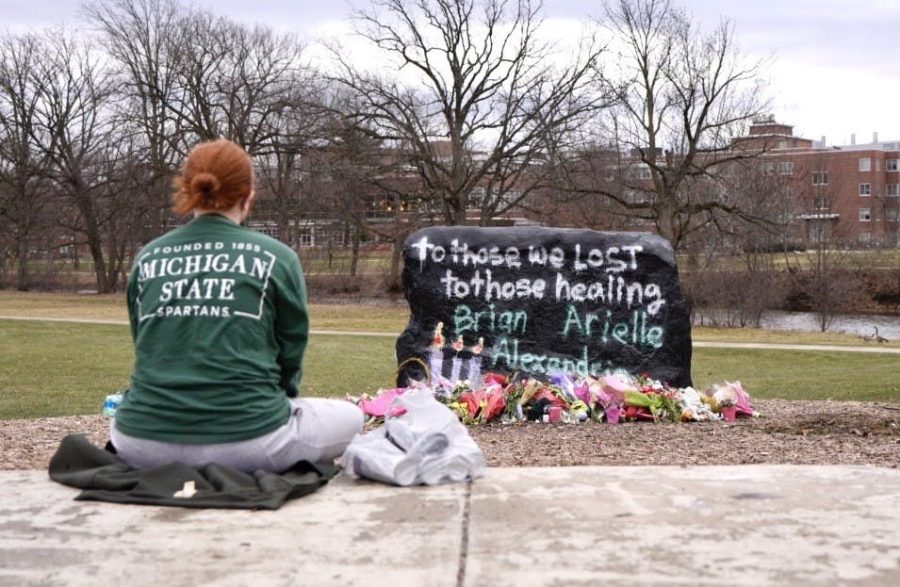 Students at Michigan State University painted the Rock, a campus landmark painted frequently to represent the thoughts of the community, with messages of hope following the recent shooting.