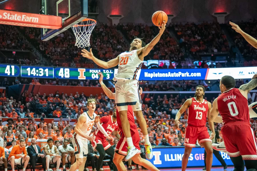 Freshman guard Ty Rodgers attempts a dunk against Nebraska on Tuesday. Along with freshman guard counterparts Jayden Epps and Sencire Harris, Rodgers played a large part in the Illinis 72-56 victory.