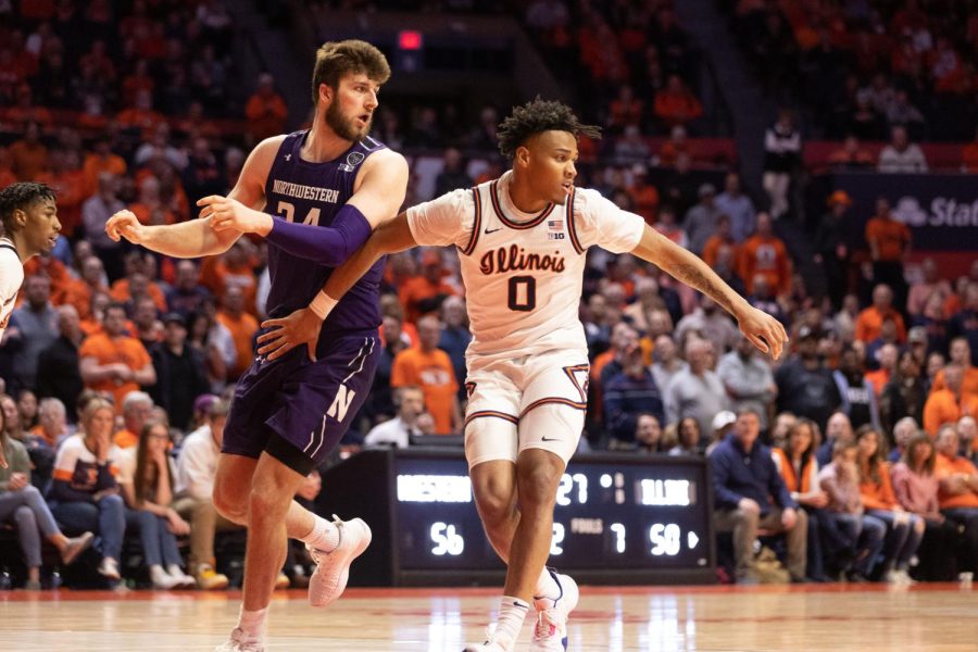 Guard Terrance Shannon Jr. blocks Northwesterns guard player Matthew Nicholson during the second half of Thursday nights game. Columnist Theodore Gary writes on missing out on watching the Illini face off against Northwestern.