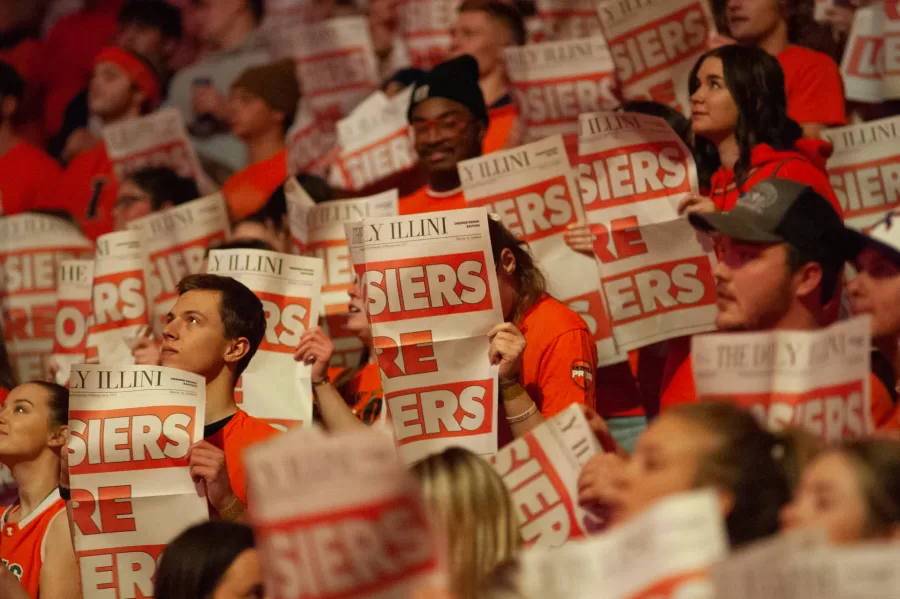 Members of Orange Krush hold up newspapers at the mens basketball game against Indiana on Jan. 19.