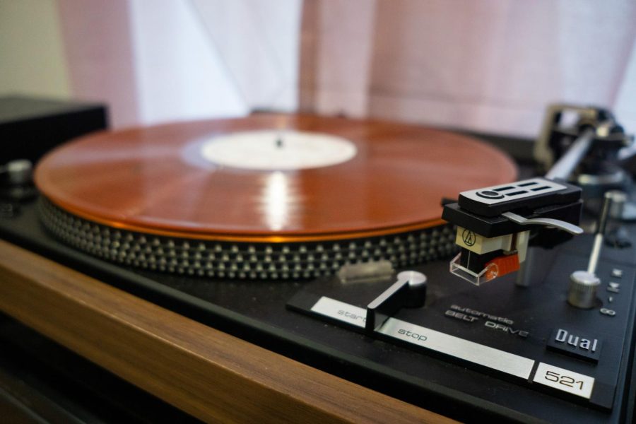 An older model of turntable with a vinyl is being shown. Records make a comeback sparing interest on the quality of them.