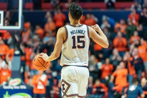 Junior guard RJ Melendez works his way down the court during a game against Wisconsin on Jan. 7. Despite a late run by Melendez and senior guard Terrence Shannon Jr. on Thursday, Illinois fell short to Arkansas, with a final score of 73-63.