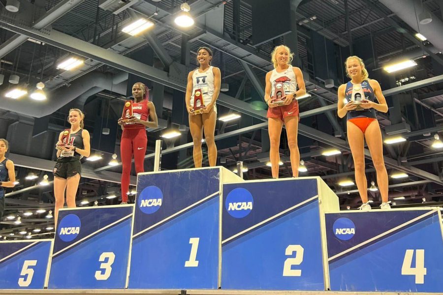 Distance track and field senior Olivia Howell on award placement stands during the NCAA indoor championships on Saturday.
Howell earned first for the Indoor Miler run during the NCAA championships, breaking a facility record for her first championship with the Illini.