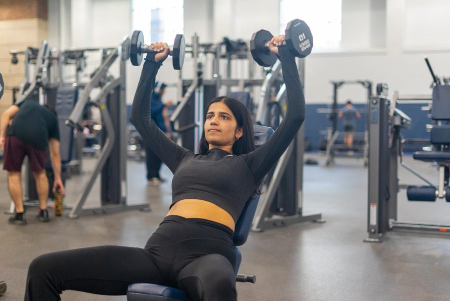 Aanya Bhatia, sophomore in LAS, does an inclined dumbbell bench press on April 14 at the ARC.