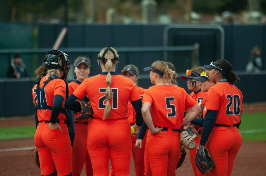 Illinois softball huddles during a game against Northwestern on Wednesday. This weekend, the Illini will travel to Michigan for a series against the Wolverines.