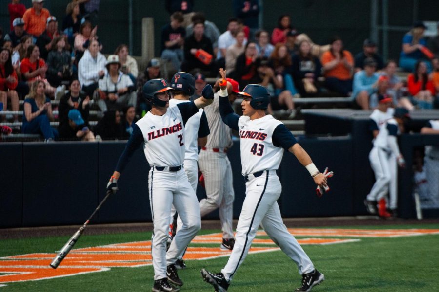 Redshirt junior infielder Brody Harding (left) high-fives sophomore infielder Ryan Moerman during a game against ISU on April 4. The Illini will travel to Bloomington-Normal to face off against the Redbirds on Tuesday.