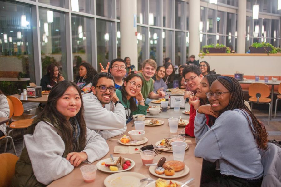 A group of friends eat at last semester’s midnight breakfast at the Ikenberry Dining Hall.