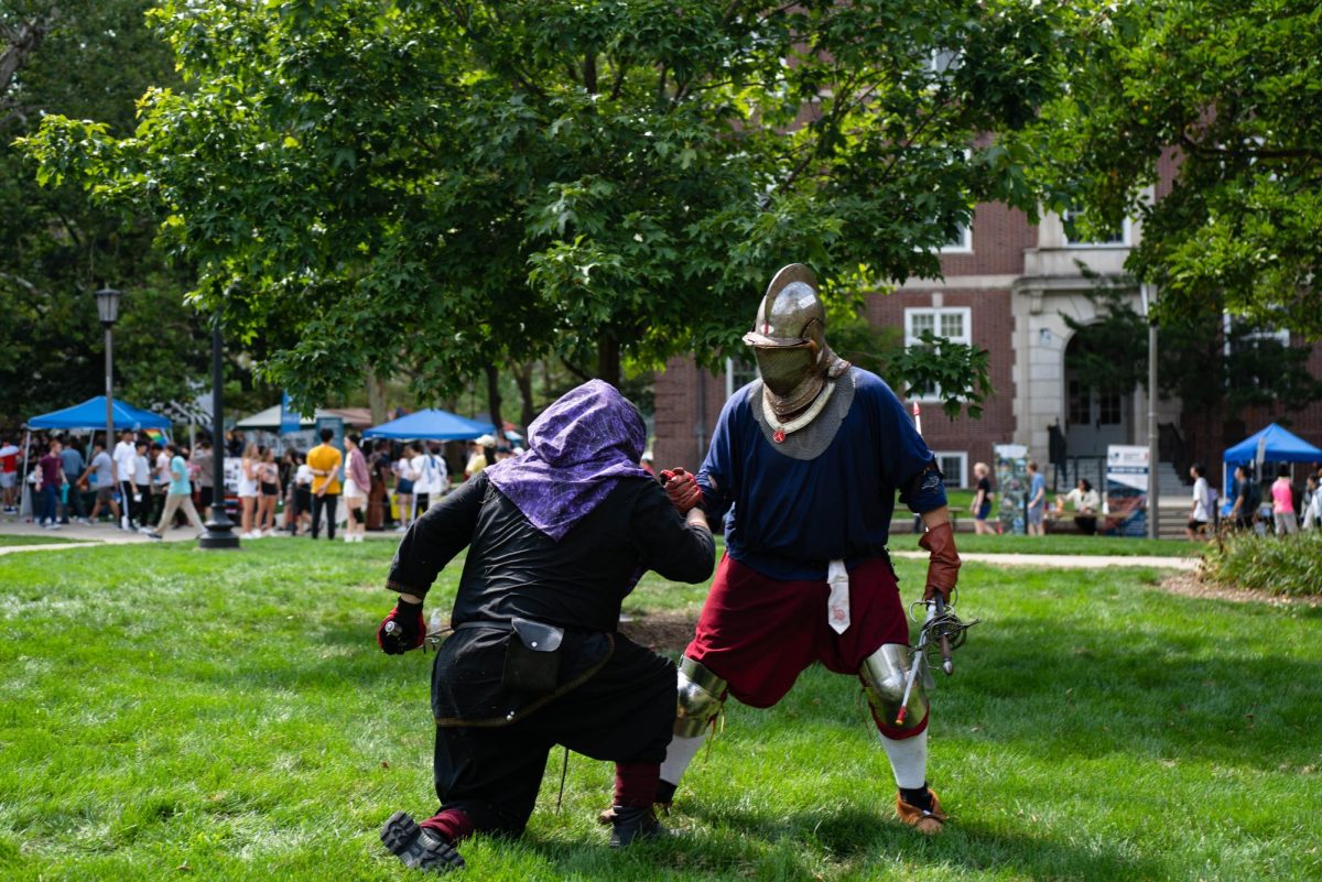 After fencing, two members of Pre 17th century century rennaissance and medieval reenactment  prepare to go another round on Sunday during Quad Day.