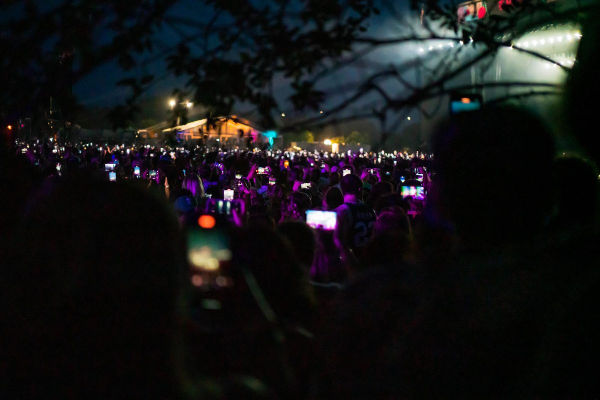 Lollapalooza attendees and fans of Billie Eilish hold out there phones to capture Billie Eilishs closing set for Lollapalooza day one on Thursday.