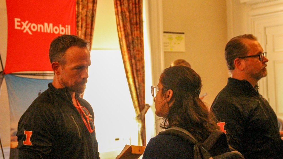 ISE PHD student Sanyukta Deshpande talks with a representative from ExxonMobil at the career fair on the second floor of the Illini Union on Wednesday. 