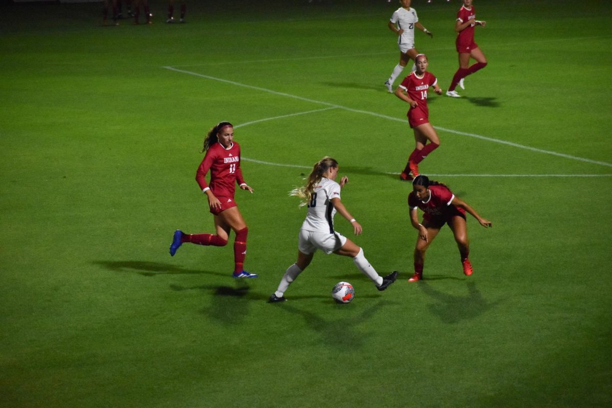 Junior midfielder Sydney Stephens dribbles past Indiana defenders on Thursday. She launches a well-placed shot into the far left corner to equalize.