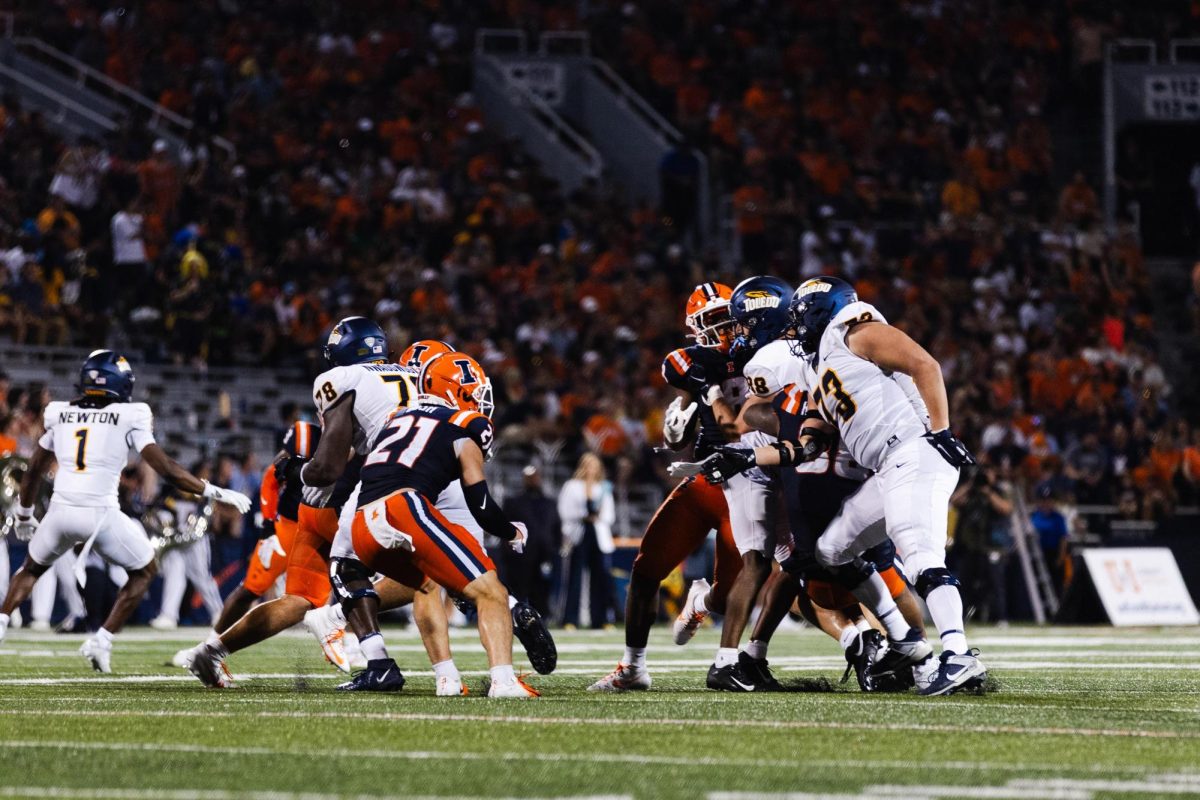 The Illini collides with Toledo during the second quarter of the first game of the seaon on Sept. 2.