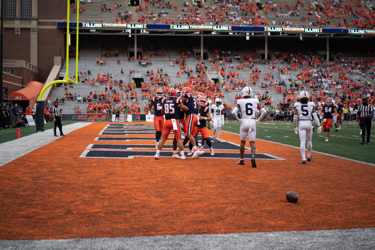 Illinois huddles together after scoring a touch down against Penn State on Saturday.