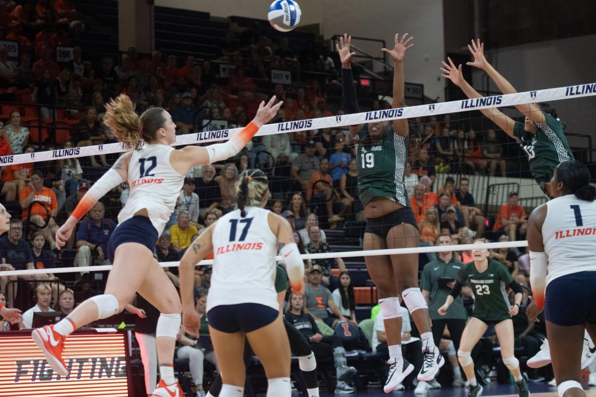 Outside Hitter Raina Terry leaps to respond to Michigans ongoing play on Sunday.
The team defeated Michigan resulting in the Illinis first Big Ten win of the season.