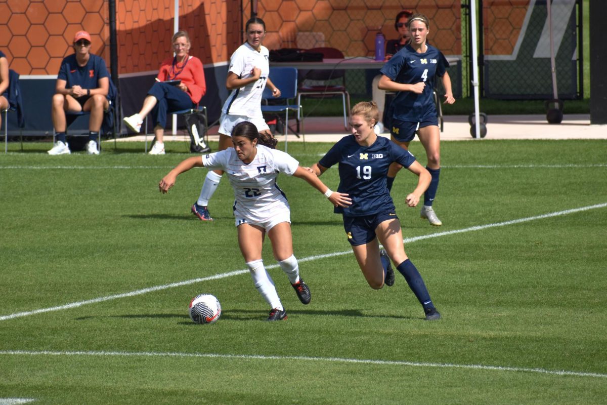 Sophomore Lia Howard keeps the ball away from Michigan junior Avery Kalitta on Sept. 24. 
Illinois fell to Michigan 1-3 on Sunday.