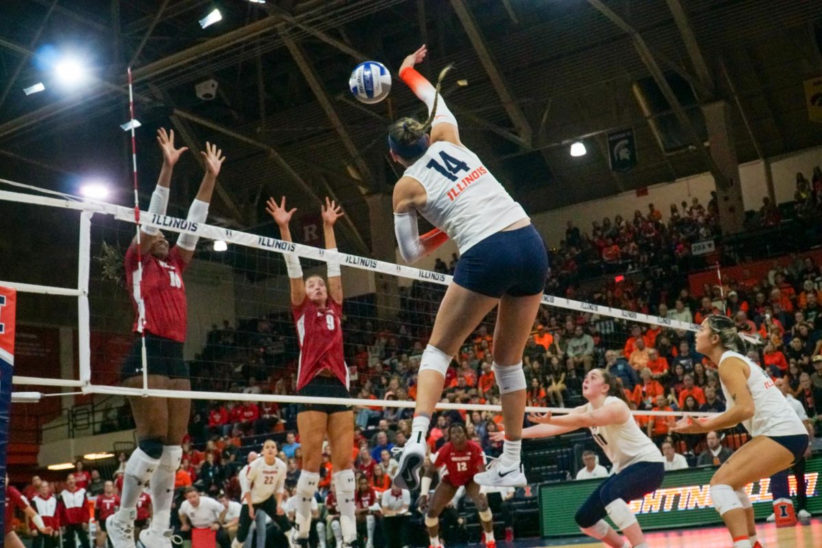 Fifth-year outside hitter Jessica Nunge leaps to spike the ball in the first set against the Rutgers Scarlet Knights at Huff Hall on Oct. 15. 