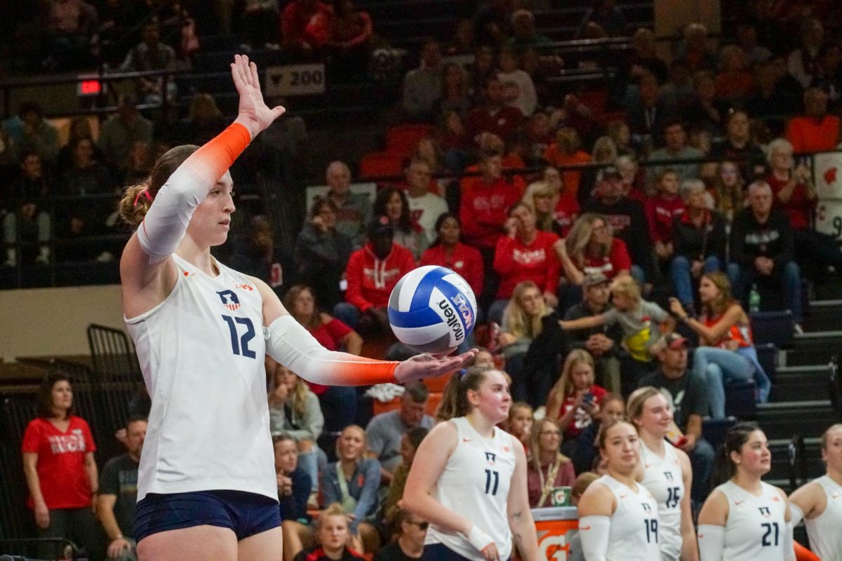 Senior outside hitter Raina Terry prepares to serve against the Wisconsin Badgers at Huff Hall on Oct. 7.