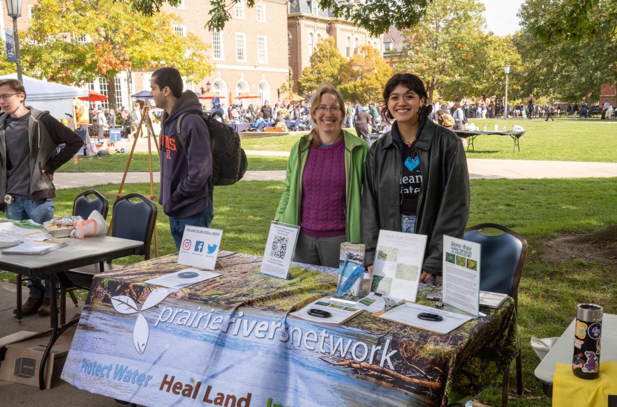 Prairie Rivers Network booth with Membership Development Associate Sarah Scott and Illinois Earth Society and Environmental Sustainability graduate Jizelle Torres on the main Quad during Green quad Day on Oct. 18. 