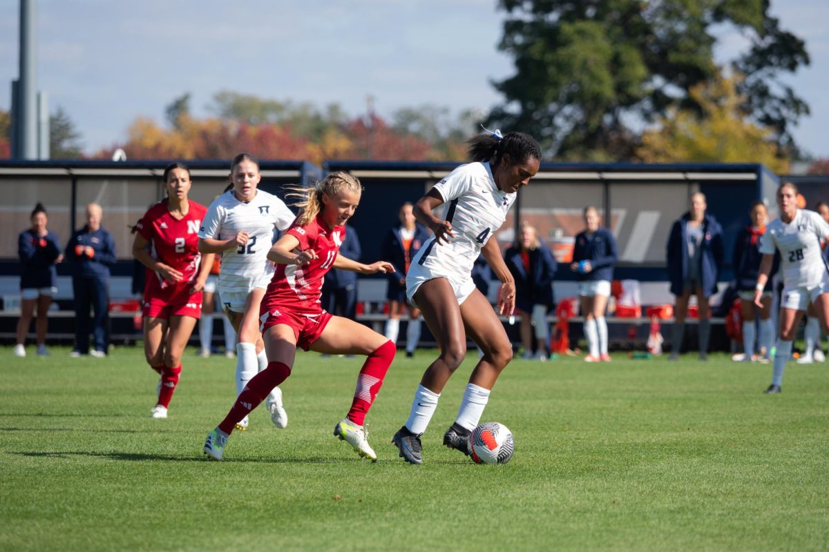 Forward Makala Woods tries to turn her defender just past midfield in the second half of the Illini soccer game against the Cornhuskers on Sunday. Woods scored one goal in her final home match for the Illini.