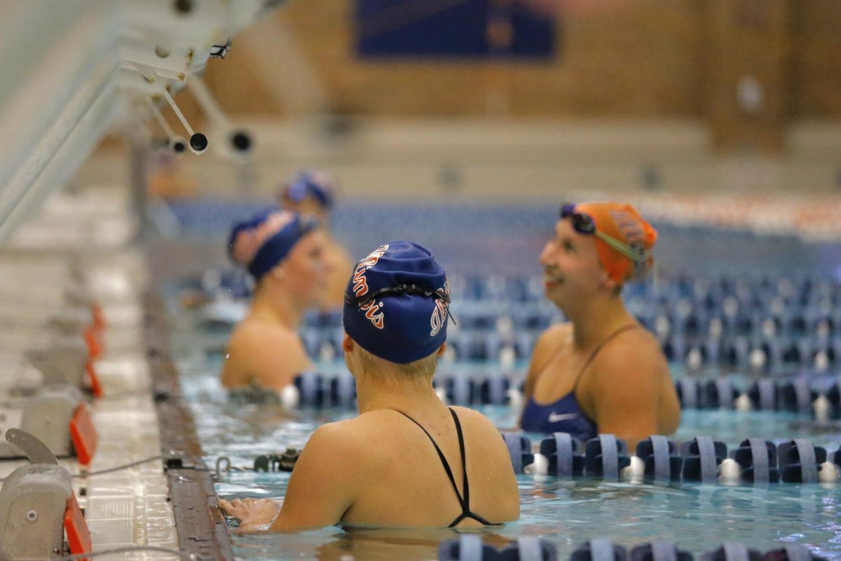 Illini swimmers rest at the end of the pool on Saturday.
The Illini will be attending an upcoming meet on Oct. 26.