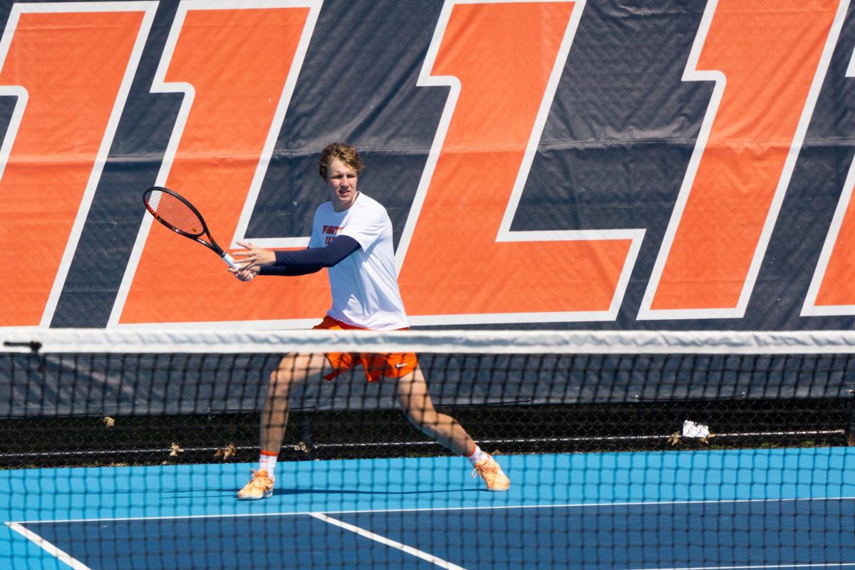 Junior Karlis Ozolins as he returns a serve from Ohio State during the doubles match at Atkins Tennis Center on Mar. 26.