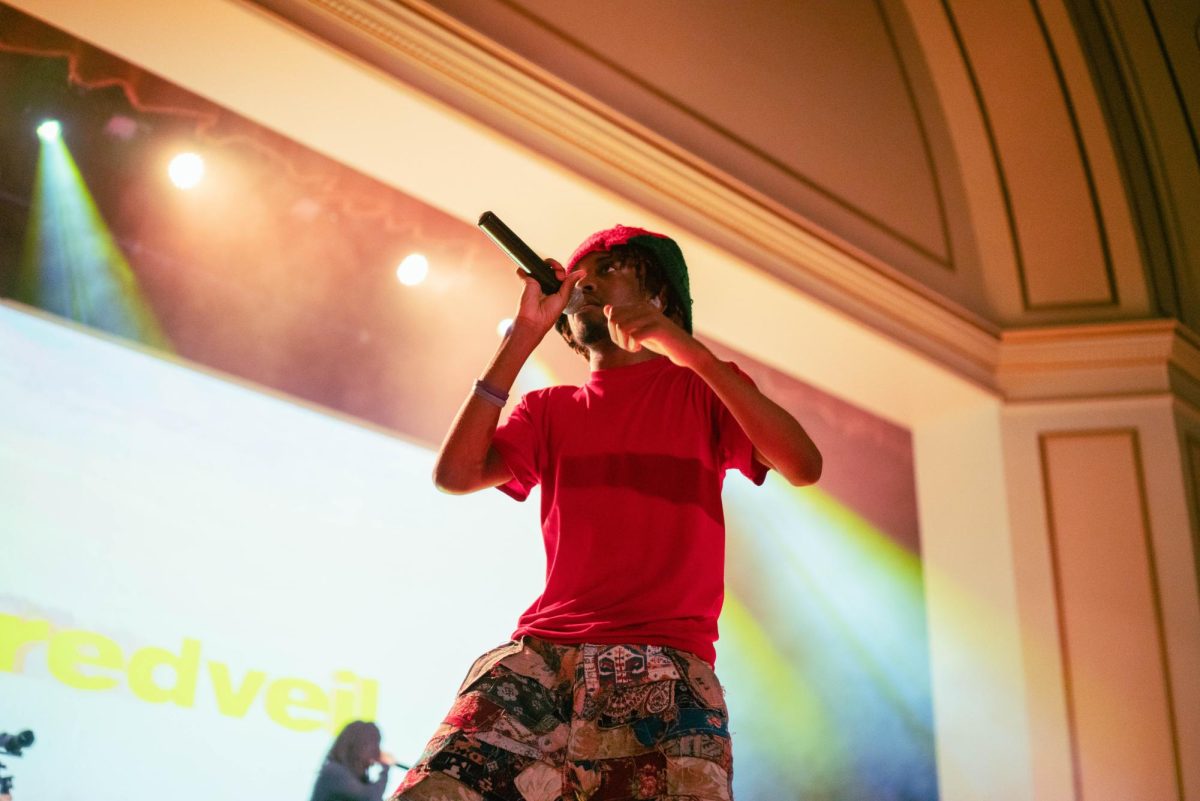 Rapper redveil performs at Foellinger Auditorium as attendees swarm the stage on Oct. 7.