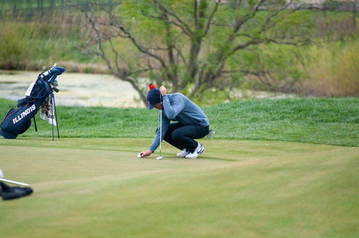 Senior Jerry Ji lines up his putt during the 2023 Fighting Illini Spring Collegiate at Atkins Golf Club on Apr. 22.