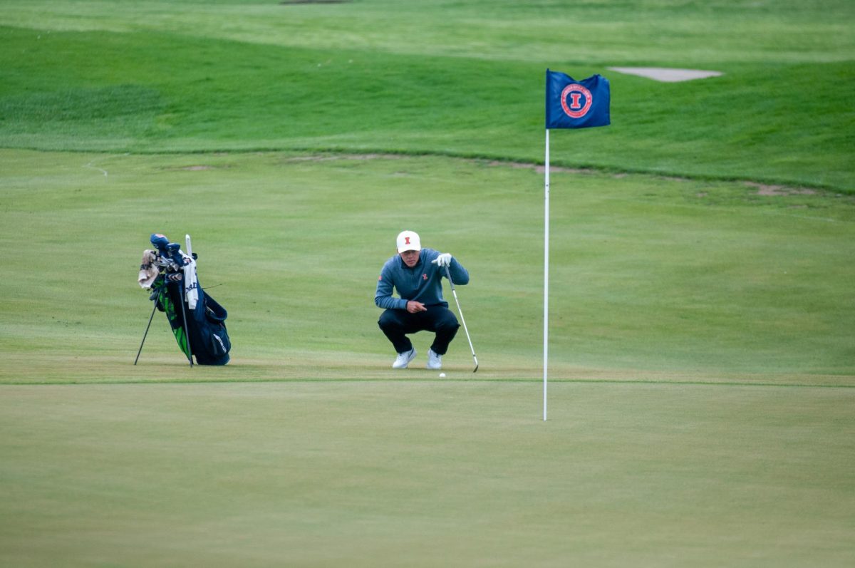 Senior Piercen Hunt reads the break of the fifth green of Atkins Golf Club at the Fighting Illini Spring Collegiate on April 22.