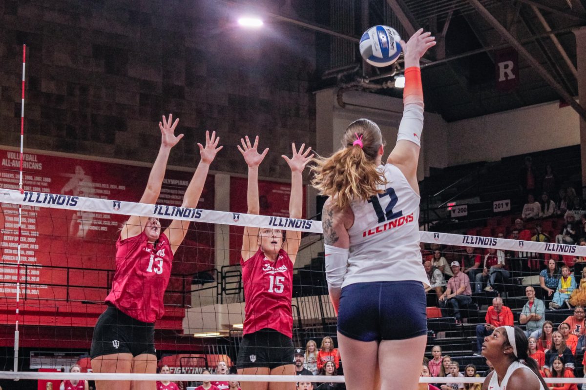 Senior outside hitter Raina Terry spikes in the first set against Indiana players at Huff Hall on Wednesday.