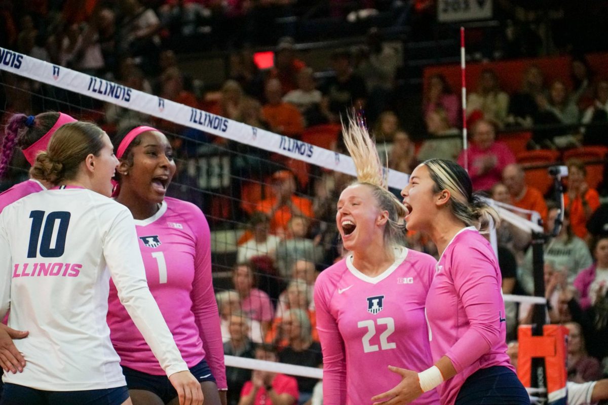 The Illini celebrate after winning a point in the first set on Saturday against Purdue at Huff Hall. 
Illinois will face Northwestern on Nov. 1.