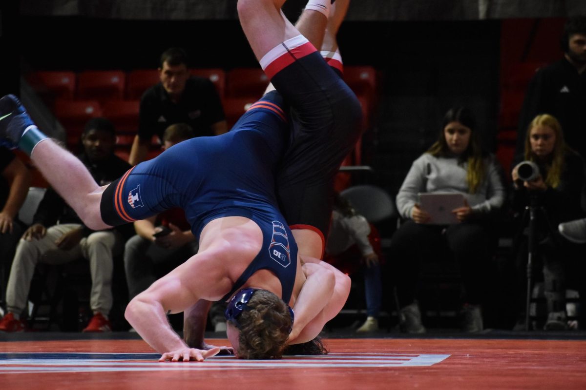 Wrestler Luke Odom flips his opponent in the match against SIUE on Thursday. Odom won with a takedown in the last 25 seconds. 