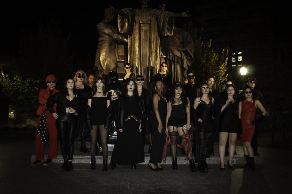 The runway ended with the models striking a pose in front of Alma Mater.