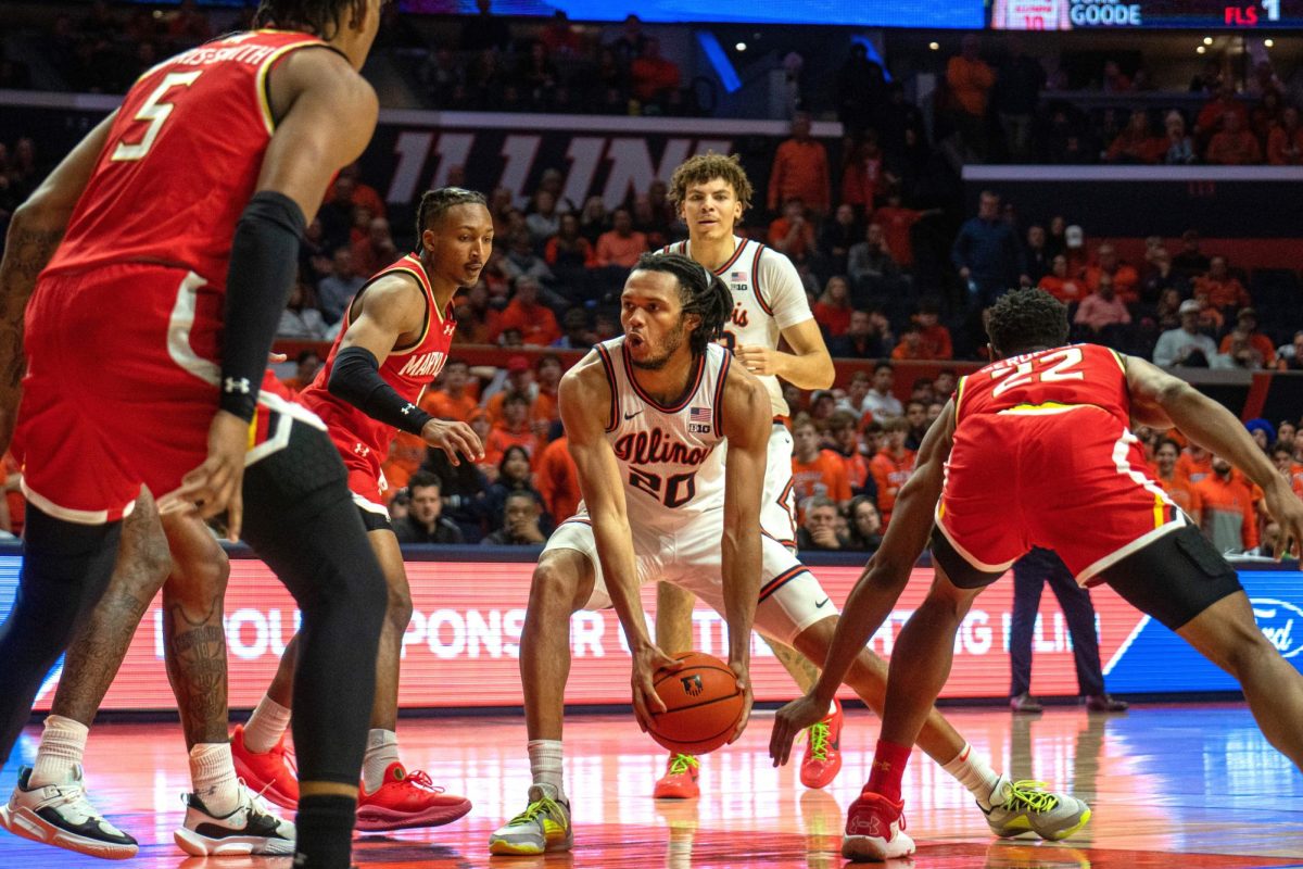 Sophomore guard Ty Rodgers scoops the ball down low to remain possession against Maryland on Jan 14.
