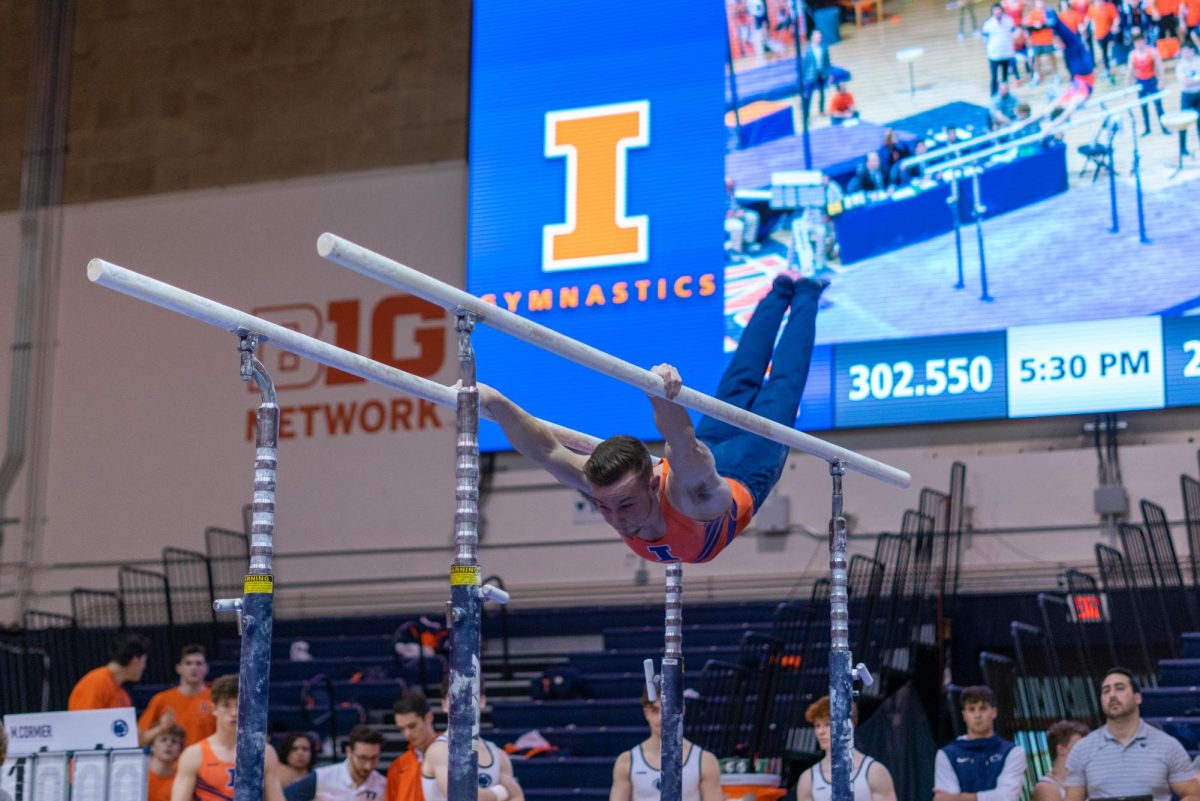Graduate+Student+Michael+Fletcher+competes+on+the+parallel+bars+during+the+Ninja+Warrior+Competition+against+Penn+State+on+Feb.+4.