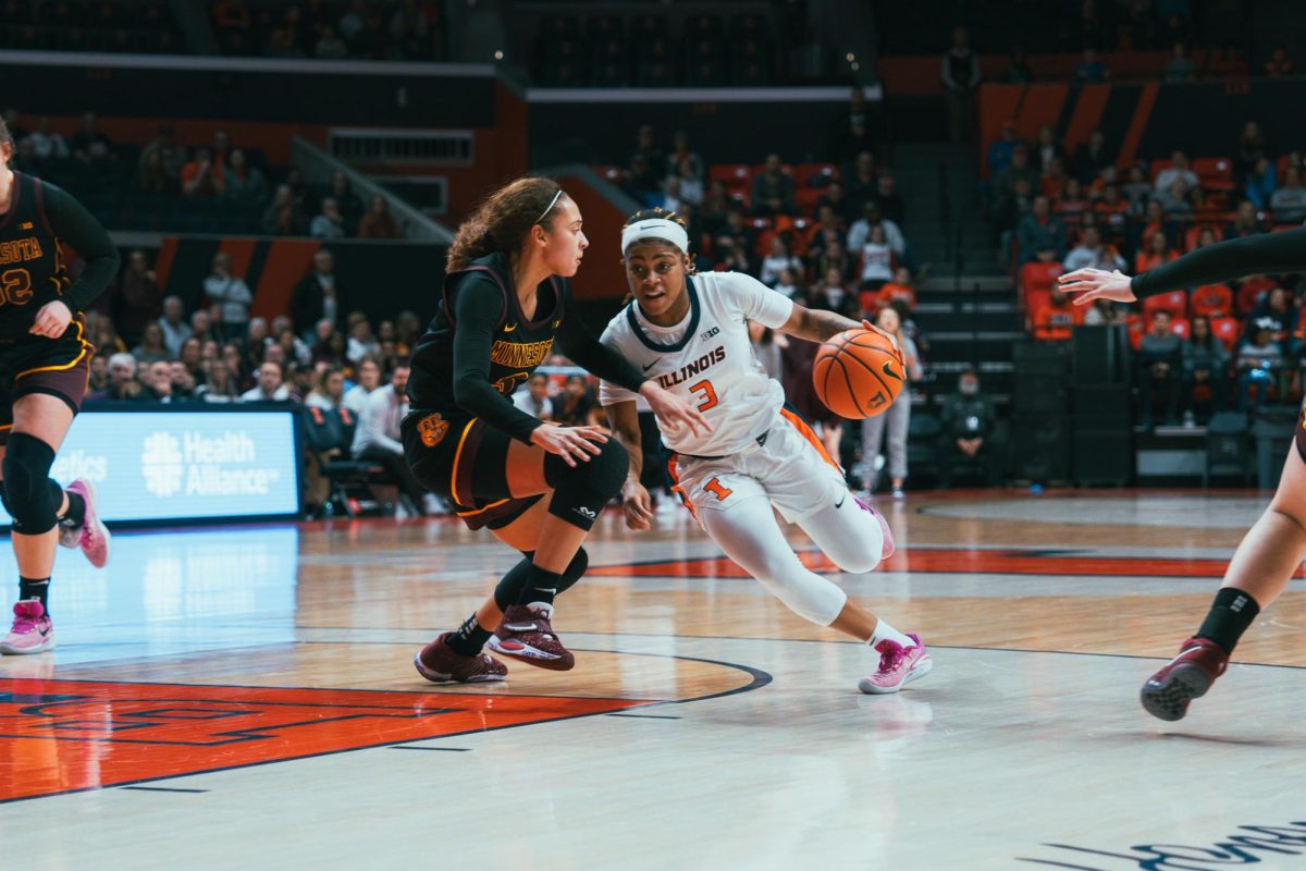 Senior guard Makira Cook carries the ball and passes the defense during the game against Minnesota yesterday. Cook scores with 22 points to her name by the end. 