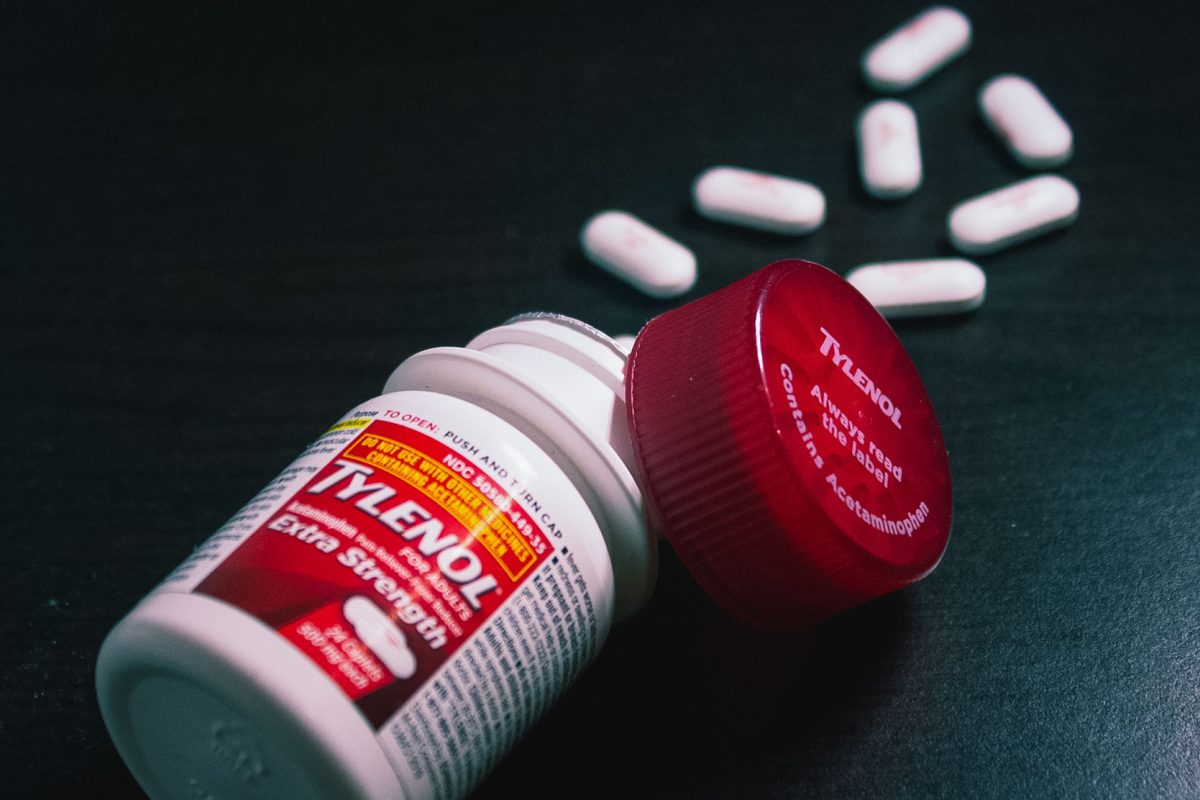 Johnson & Johnson Tylenol pain reliever pills spill on a table. In a recent University study, researchers suggest a link between pregnant people taking acetaminophen and their child’s language development.