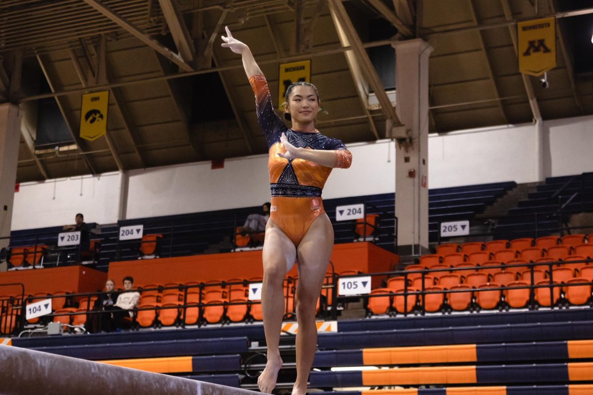 All-Around+senior+Mia+Takekawa+steps+to+the+beam+facing+off+against+Michigan+State+on+Feb.+27+2023.+The+match+ended+in+a+loss+for+the+Illini.