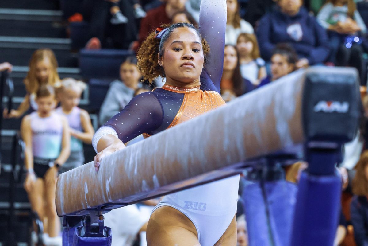 All-around+Mia+Townes+poses+next+to+the+beam+against+Rutgers+on+Sunday.+