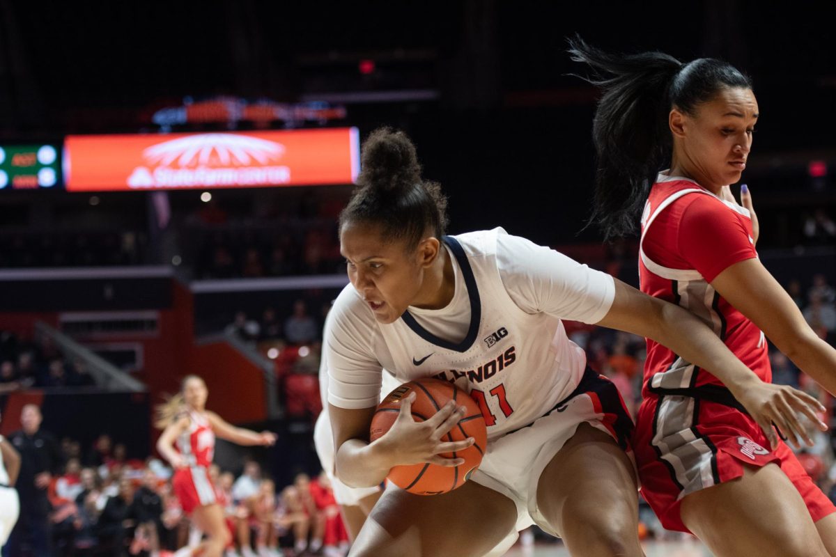Fifth-year Center Camille Hobby shields the ball and passes the defender during the game against Ohio State on Jan. 25. 