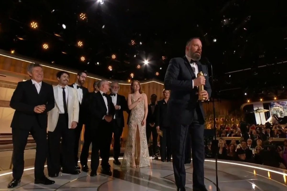Poor Things cast and crew come up on stage to receive a Golden Globe at the 81st Golden Globe Awards on Sunday.