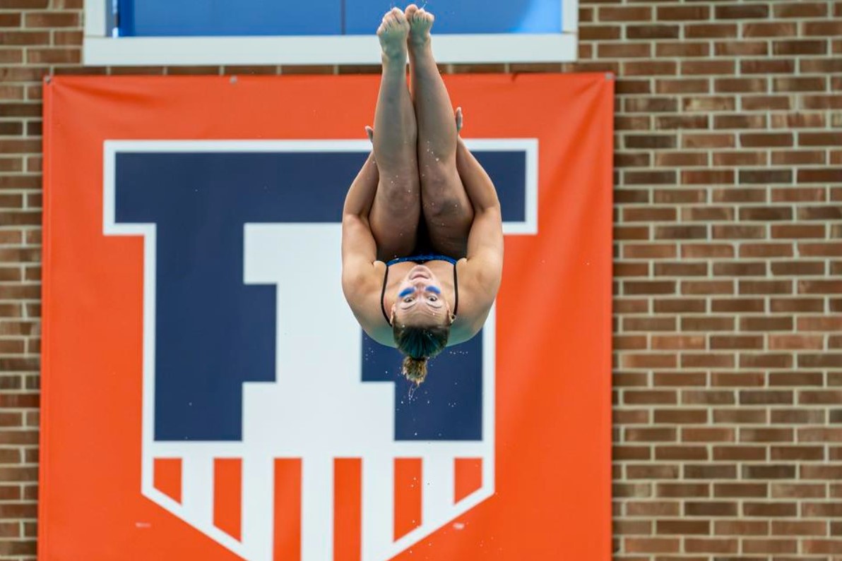 Freshman Bethany Mercer flips into the pool on Oct. 7, during the Orange and Blue meet.
