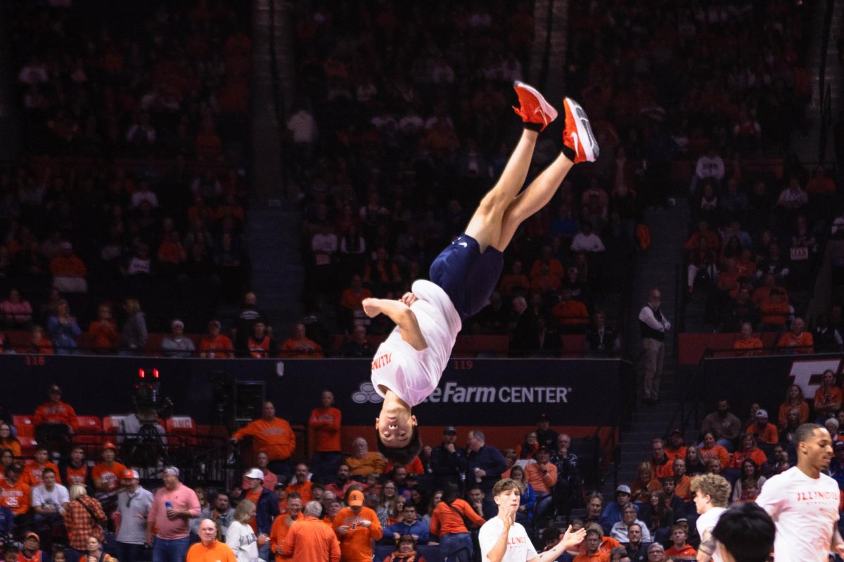 Pommel horse Branon Dang stunts a flip in the middle of the State Farm Center during a halftime show performance for mens basketball on Oct. 29.