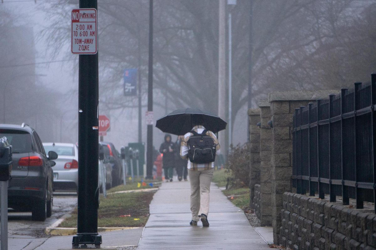 A student walks to classes sheltered with an umbrella at Nevada Street on Jan. 25, amongst high fog and misty weather throughout the day.
