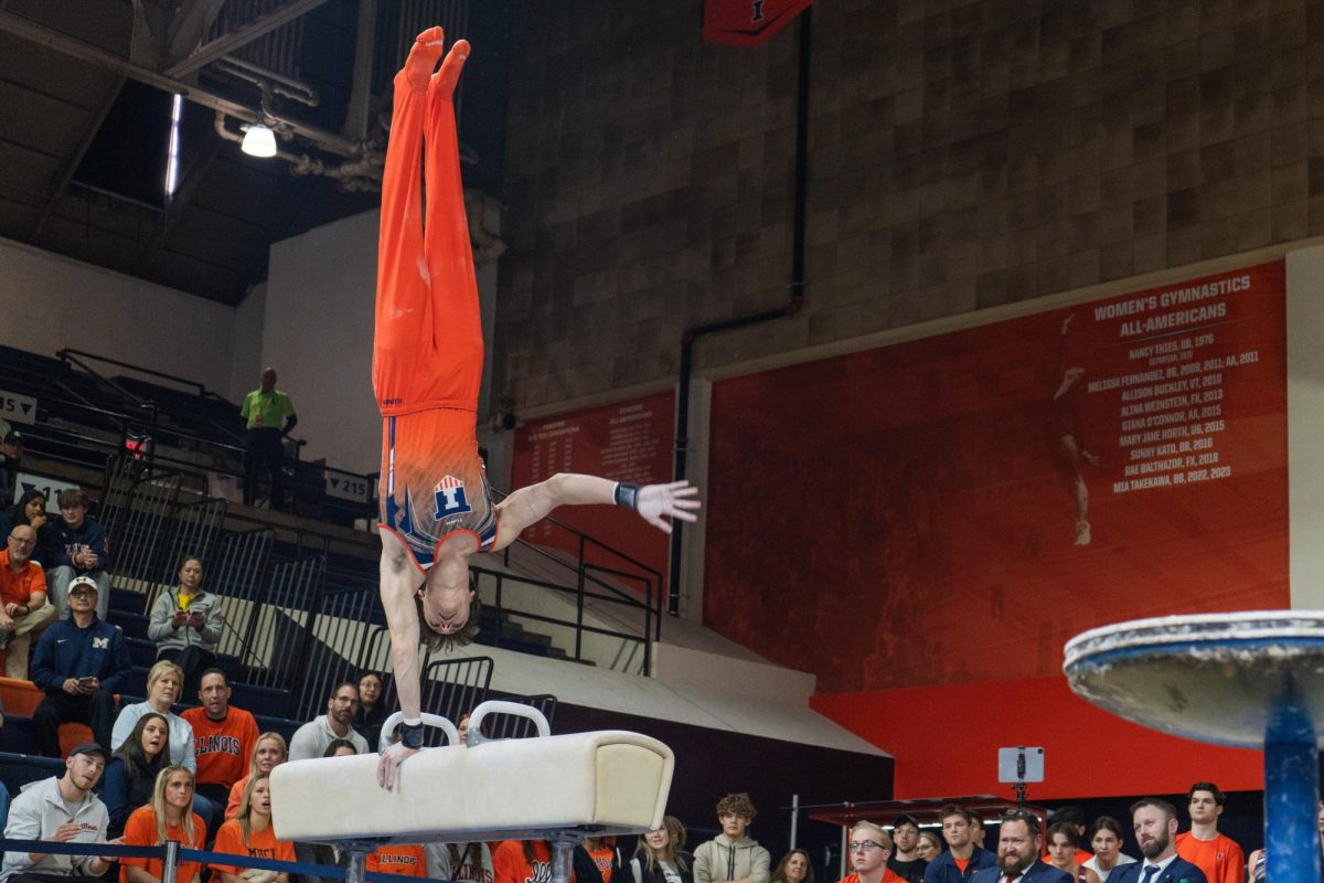 
Junior Max Farkhadau showcases a one-handed handstand during his pommel horse routine at Huff Hall on Feb. 3.