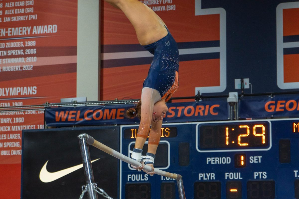Freshman Lyden Saltness prepares a big swing on the uneven bars during the meet against Minnesota on Feb. 18. 